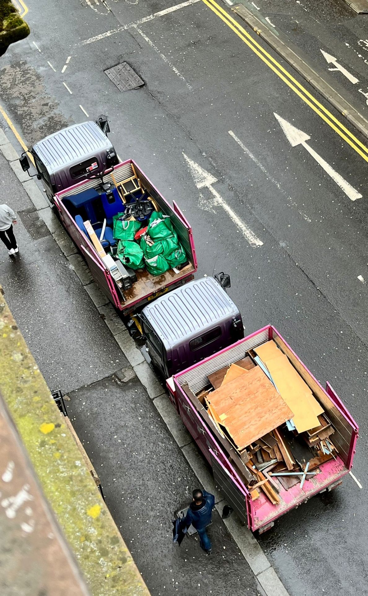 Three Jettison Express pink lorries lined up on a Glasgow street